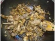 捞出小公鸡，倒入锅中炒至水份干掉，倒入少量的酱油上色，倒入料酒炒一炒。 